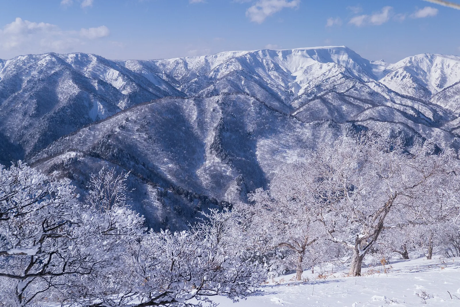Snow-covered ridgelines of Mount Naeba above the Yuzawa valley